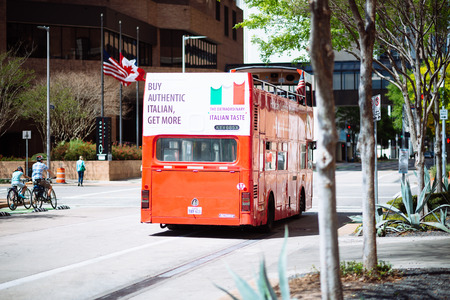 HOUSTON, TEXAS - March 2016: Street scene in Houston Downtown with bouble deck red bus on sunny day on March 2016 in Houston, United States. Buy authentic Itallian add on the bus.のeditorial素材