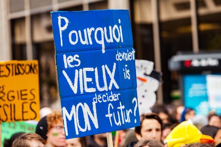 French sign held at ecological protest. A close up view of a French placard reading why should old people decide my future as environmentalists march on a street in Montreal, Canadaの写真素材