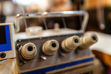A closeup view of the spool control dials on a vintage overlock machine. Old-fashioned retro...