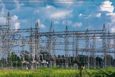 Electrical central where can be seen electric transmission pylons, supporting high voltage lines with visible insulators and other industrial components.の写真素材