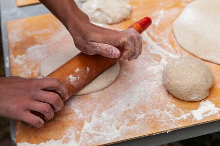 Pictures taken during a bread and pizza making workshop with many people from all ages and...