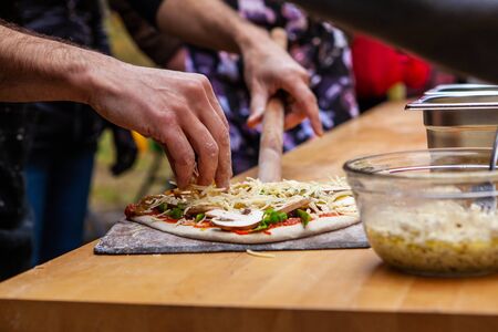 Pictures taken during a bread and pizza making workshop with many people from all ages and...