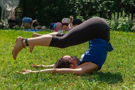 A close up view of a young caucasian woman practicing yoga, Diverse people enjoy outdoor yoga...