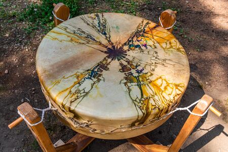 Close Up of Sacred tribal drum on the ground outdoors in the woodland, spiritual shamanic...