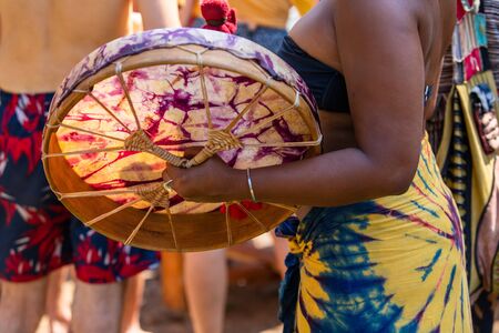 Sacred drums during spiritual singing. a close up on black woman hand playing shaman drum during a...