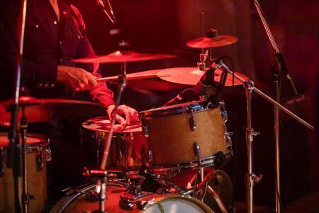 Fusion of cultural and modern music event. Drummer playing the drums, close up on Percussion Drum...