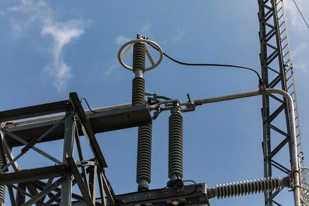 High voltage insulators and a metal corona ring, A corona ring or anti-corona ring, towers and...
