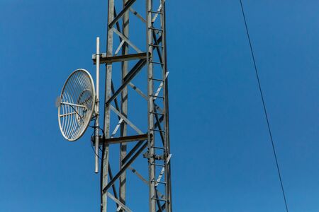 small communication satellite on the tower in an electrical substation, against the sky, Used for remote control and monitoring of the substationsの写真素材