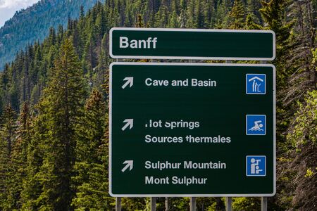 Canadian two languages French and English Information road green signs, Banff Town, cave and basin, hot springs, sulphur mountain, Alberta, Canadaの写真素材