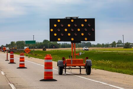 A close up shot of an LED mobile matrix keep left sign, with orange flashing lights warning...