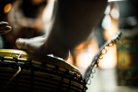 Played by blurred non recognizable percussionists musician. Fast hands playing on the drum. Authentic closeup musical instrument.の写真素材