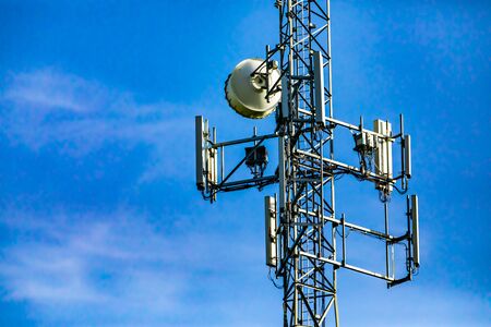 A close up view on the electronic components that make up a cell site tower, multiple antenna and...