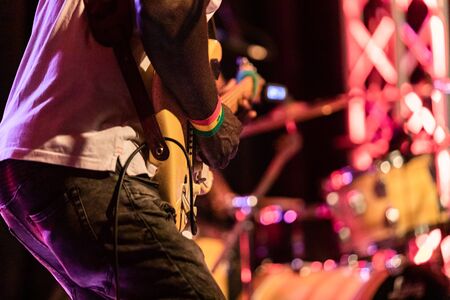 Closeup of african professional male musician wearing white t-shirt and playing electric guitar on...