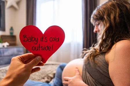 A conceptual message with shallow depth of field, pregnant woman prepares for home birth in...