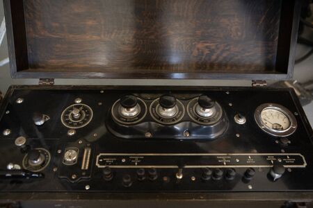 An old vintage control panel with voltmeter. Close-up view of antique controlling engine. Industrial...