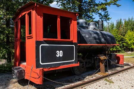 Antique train in the railways museum. A vintage steam train under the sunny sky. A little locomotive...