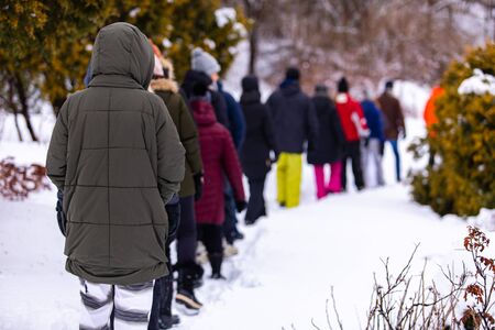 The morning walk of a group of people from camping. The people who step by step follow each other in...
