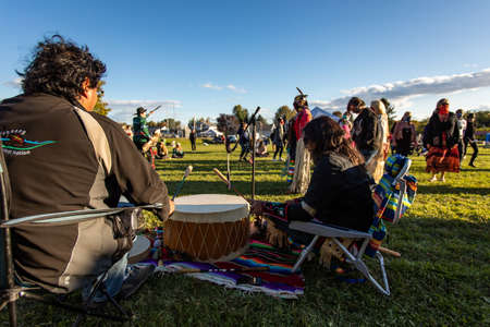 Outaouais, Quebec - September 19, 2020: Group of male musicians sitting together playing native sacred circle drums in cultural fiesta in parkのeditorial素材