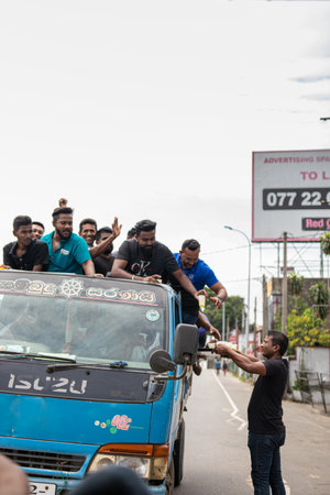 COLOMBO, SRI LANKA: 9th July 2022: Raw shot of a local man giving refreshments to demonstrators on a van during the mass anti government protest.のeditorial素材