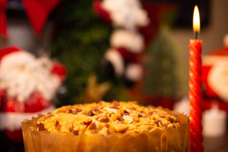 Fruit panettone covered with chestnuts on a table decorated for Christmas. Selective focus.の写真素材