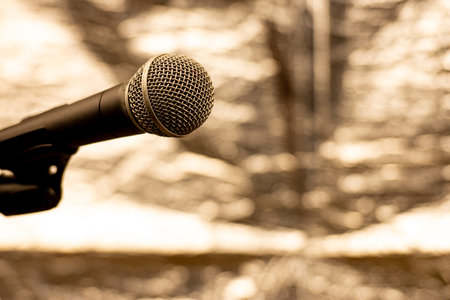 Isolated microphone, on a pedestal, on a blurred silver background. Selective focus.の写真素材