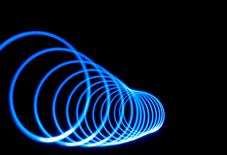 Electric blue tunnel of light. Spiral shaped light trail.の写真素材