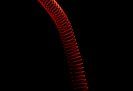 Red vertical spiral shaped light tunnel. Design element for game design or web.の写真素材