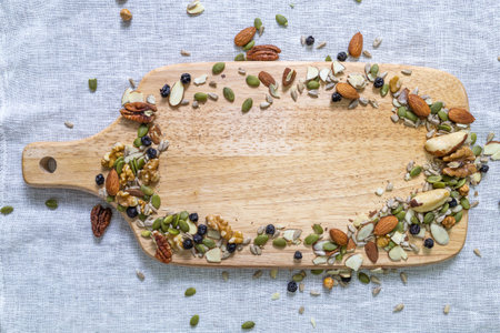 Nuts on a serving board, top view, top view.の写真素材