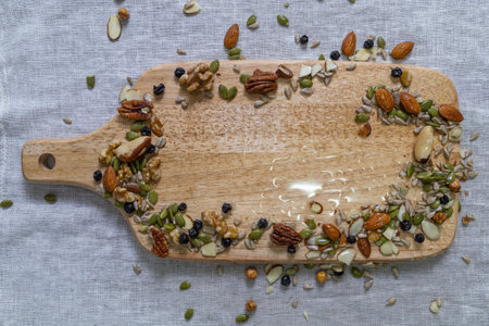 Nuts on a serving board, top view, top view.の写真素材
