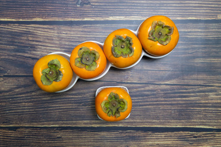 Persimmon on the table, top view.の写真素材