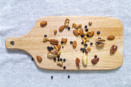 Nuts on a serving board, top view, top view.の写真素材