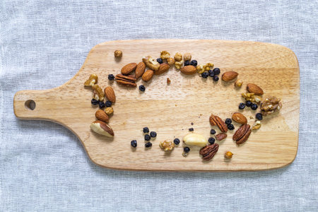 Nuts on a serving board, top view, top view.の写真素材