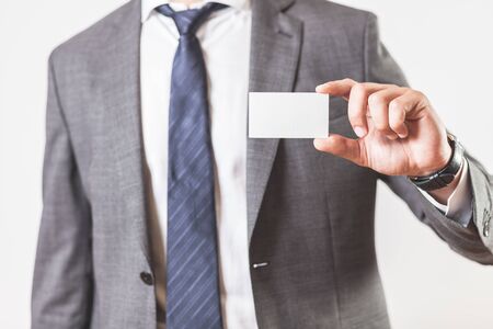 Man holding and showing a blank business card