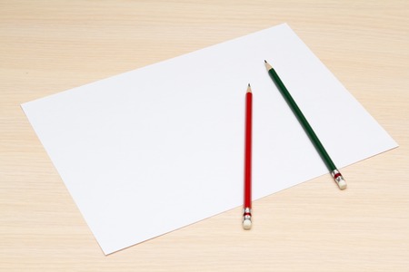 a blank sheet of paper with two colored pencilsの写真素材