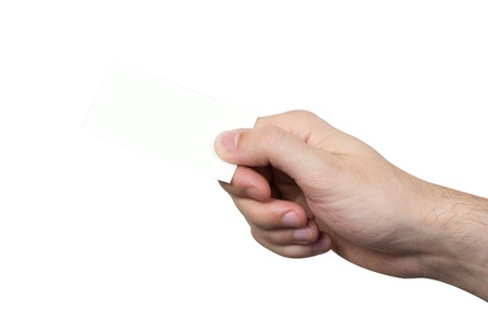 business card in a male hand isolated on white backgroundの写真素材