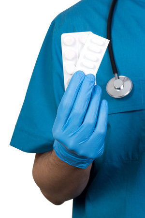 unknown male surgeon holding pills in hand isolated on white backgroundの写真素材