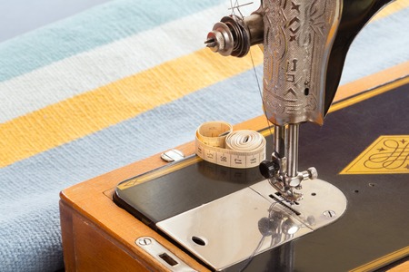 The Old black sewing machine wiht soft meter on it