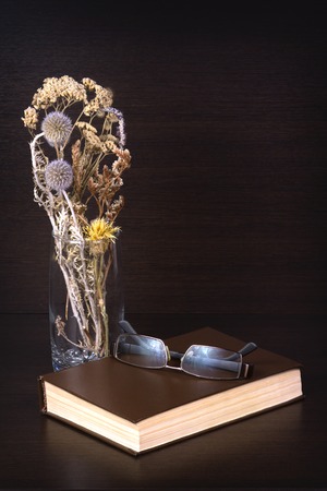 The Brown book with glasses on a tableの写真素材