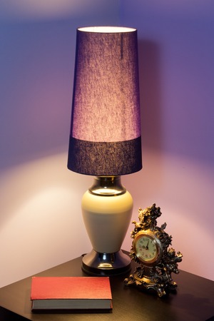 The book is lying on the table in the light of a desk lampの写真素材