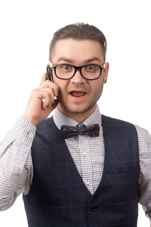 Young attractive guy talking on the phone isolated on whiteの写真素材