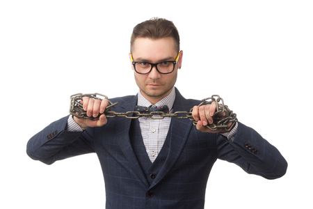 young businessman with chains on  hands, isolated on whiteの写真素材