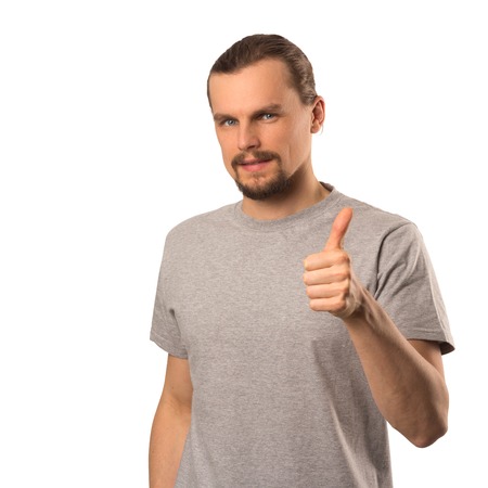 Bearded attractive caucasian guy holding thumb up isolated on white backgroundの写真素材