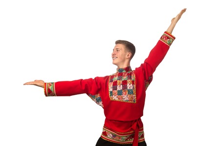 Attractive russian guy dancing in folk costume isolated on white backgroundの写真素材