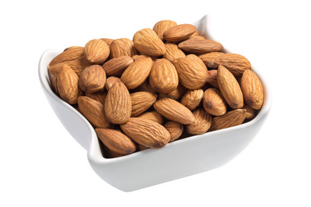 Raw almonds in a white plate isolated on white backgroundの写真素材