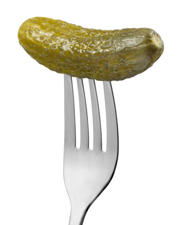 Pickled cucumber on a folk isolated on white backgroundの写真素材