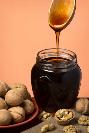 Forest-steppe herb honey in a glass jar on beige backgroundの写真素材