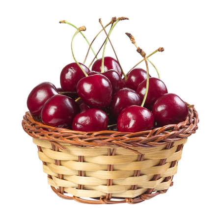Cherry in a wicker basket isolated on white backgroundの写真素材