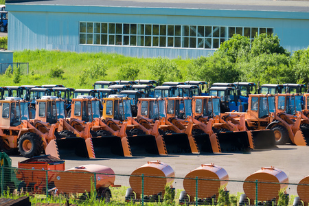 new construction equipment, bulldozers and tractors in the Parking lot