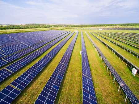 close-up of solar panels on green grass with blue sky