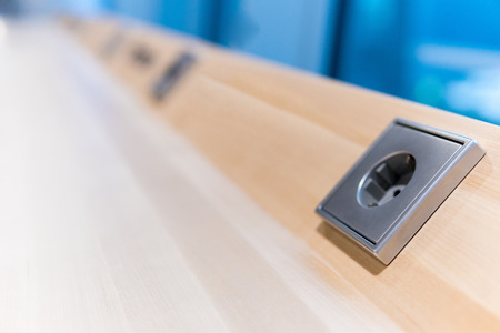 grey electrical socket on brown wood boards. electrical outletの写真素材